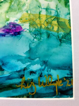 Flowing inks across the page look like volcanic rock all the way down to some greenery and the  blue, turquoise seas

Framed in a silver frame with white mat board.