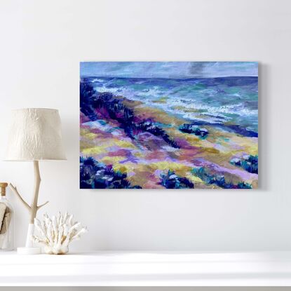 A sand beach and dune in the foreground with the ocean in the background, and the sky above, all painted in blues, yellows, pinks and greens.