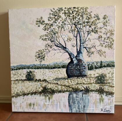 Bottle or boab tree in a rural setting with a light pink sky near a waterhole, with reflections in water. 