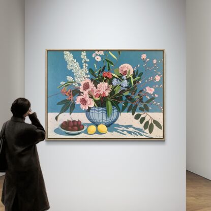 A still life painting of flowers and fruit in blues, reds, oranges, yellows, whites, pinks and greens, framed in oak