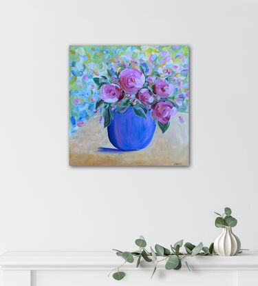 Big  pink vibrant Camelia's in blue vase.