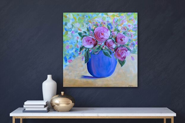 Big  pink vibrant Camelia's in blue vase.