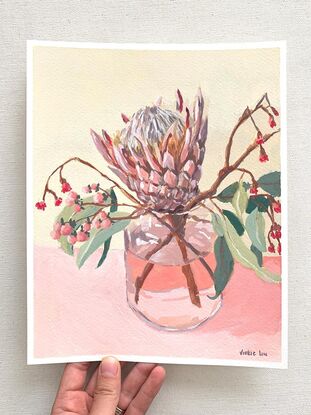 Protea and gum flowers in vase on pink background