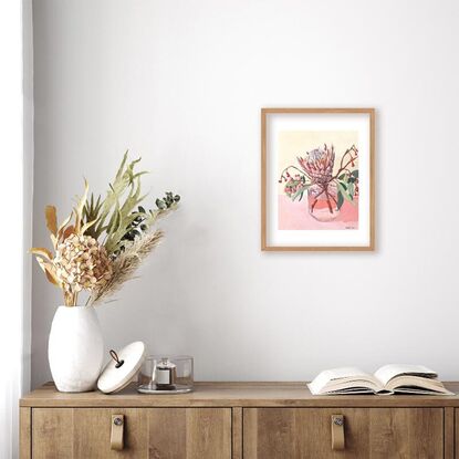 Protea and gum flowers in vase on pink background