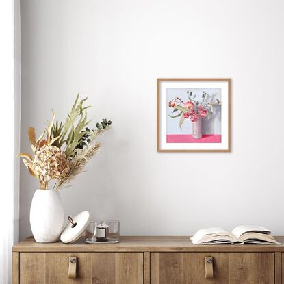 Pink daisy flowers and gum bouquet in white vase on pink background