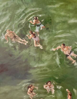 People at the beach swimming in green water