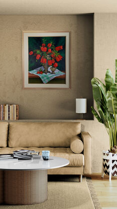 A vase of red bottlebrush on a green and white tablecloth.