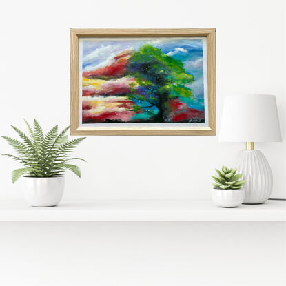 Dancing with the Clouds

This captivating painting, elegantly framed, captures the wild beauty of nature's dance.
 A resilient green tree, bending sideways in the wind, takes centre stage,  swaying with dynamic energy. 

The backdrop is a dramatic symphony of fiery clouds, ablaze with shades of red, orange, and gold, casting an enchanting glow across the scene. 

Tiny, luminous specks flutter around the tree like fireflies, adding a touch of whimsy and magic to the composition. 
These delicate lights seem to dance in harmony with the tree, creating a mesmerizing interplay between the elements. 

"Dancing with the Clouds" is a visual ode to the raw power and delicate grace of nature, inviting viewers to lose themselves in its tempestuous yet serene embrace. 

This piece will undoubtedly bring a sense of movement and wonder to any space it touches .