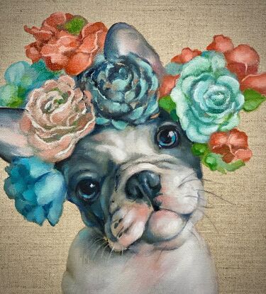 A grey and white French Bulldog puppy wearing a flower crown.