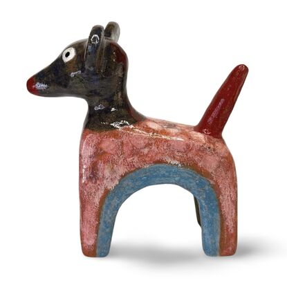 This stoneware sculpture features a stylised puppy distinguished by its vibrant, multi-colored glaze and  large ears and a pronounced snout. The colour and simple form highlight the fun nature of the piece.