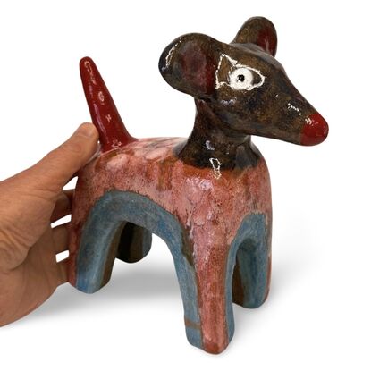 This stoneware sculpture features a stylised puppy distinguished by its vibrant, multi-colored glaze and  large ears and a pronounced snout. The colour and simple form highlight the fun nature of the piece.