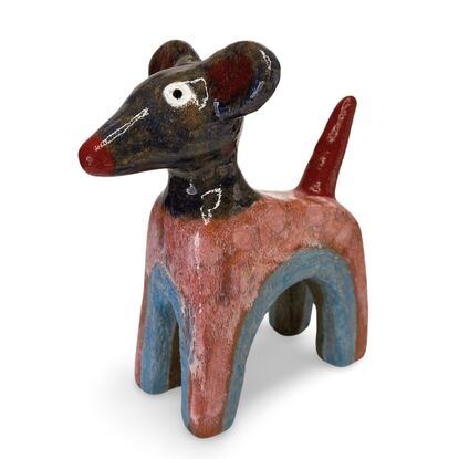 This stoneware sculpture features a stylised puppy distinguished by its vibrant, multi-colored glaze and  large ears and a pronounced snout. The colour and simple form highlight the fun nature of the piece.