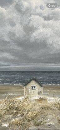 Lonely white shack on beach with puffy white clouds.