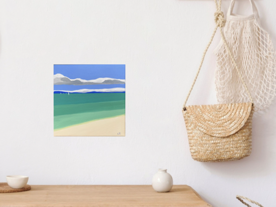 A simplified painting of the ocean from the sandy beach, with colour blocks gradually getting darker in the distance. There is blue land on the horizon and sailing boats in the distance with a ribbon of grey and white cloud in the blue sky.