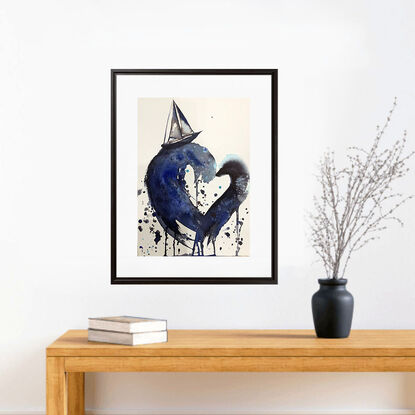 “My Sailing Heart” by Sydney artist Leni Kae is a watercolour seascape painting featuring large waves in a heart shape, with a sailboat on top; carrying symbolism of love, the search for love and new journeys of the heart. Indigo, deep blue, and light blue tones. 