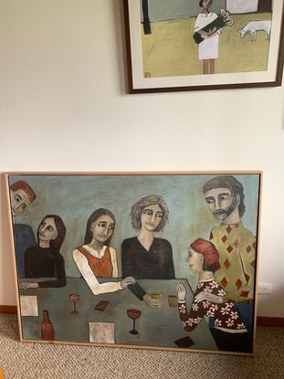 The painting depicts a  group of men and women standing around a table. There are wine glasses and bottles on the table. The people are at a party.