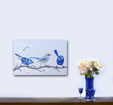 Textured oil painting of three little Splendid Fairy Wrens on a perch of white plum blossom, a male on either side of the female in the centre.  The males have a light blue head, darker blue front and back and a black stripe across the chest and near the eyes. The female is a paler grey with blue tips on the wings and tail.