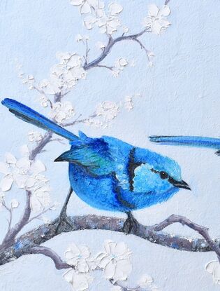 Textured oil painting of three little Splendid Fairy Wrens on a perch of white plum blossom, a male on either side of the female in the centre.  The males have a light blue head, darker blue front and back and a black stripe across the chest and near the eyes. The female is a paler grey with blue tips on the wings and tail.