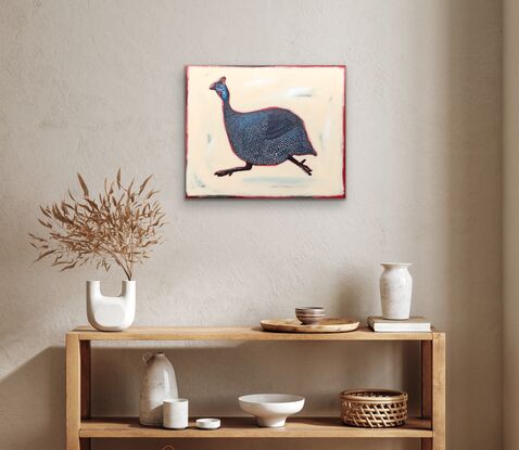 Guinea fowl running on a beige abstract backgroun, red and brown edges.