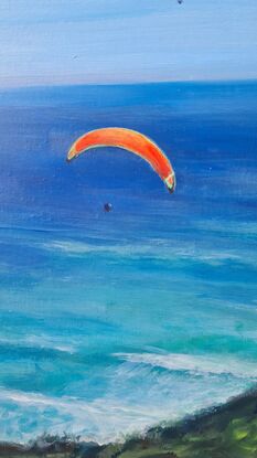 Colourful Paragliders brightly light  a peaceful blue sky, #paragliders soaring High, sailing through a smooth clear blue sky with a #peaceful clear blue ocean greeting them from below.