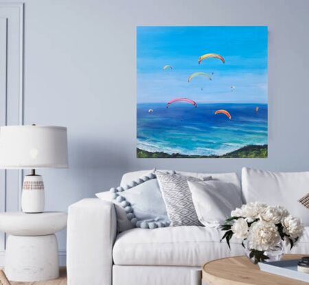 Colourful Paragliders brightly light  a peaceful blue sky, #paragliders soaring High, sailing through a smooth clear blue sky with a #peaceful clear blue ocean greeting them from below.