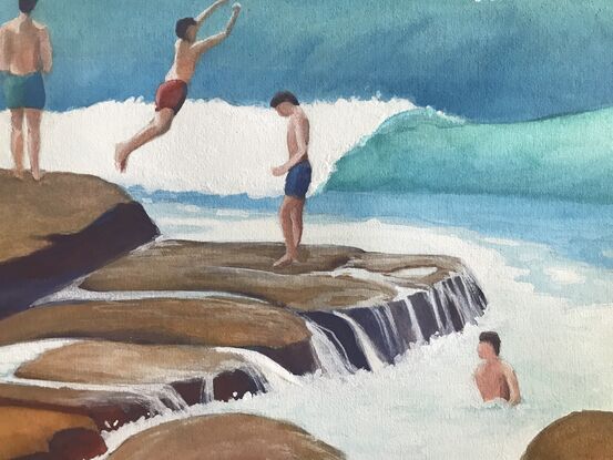 Young boys are taking turns jumping off the rich brown/ochre rocks into the turquoise waves at the seaside.