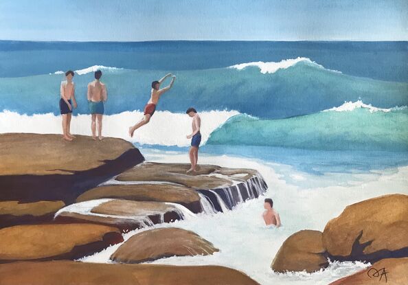 Young boys are taking turns jumping off the rich brown/ochre rocks into the turquoise waves at the seaside.