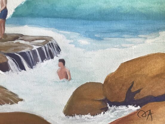 Young boys are taking turns jumping off the rich brown/ochre rocks into the turquoise waves at the seaside.