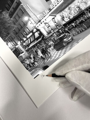 Black and white photograph of crowd outside Moulin Rouge Cabaret in Paris