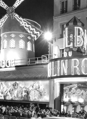 Black and white photograph of crowd outside Moulin Rouge Cabaret in Paris