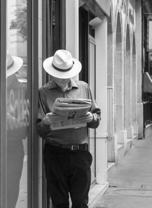 Black and white photograph of narrow street in Paris, France