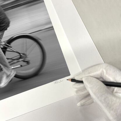 Black and white photograph of cycling in street Paris, France