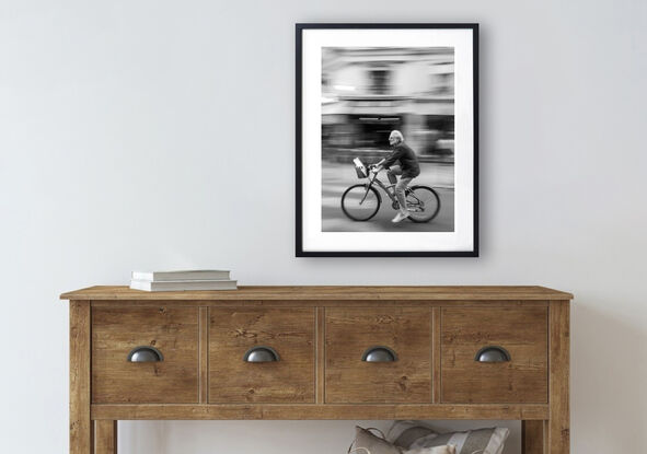 Black and white photograph of cycling in street Paris, France