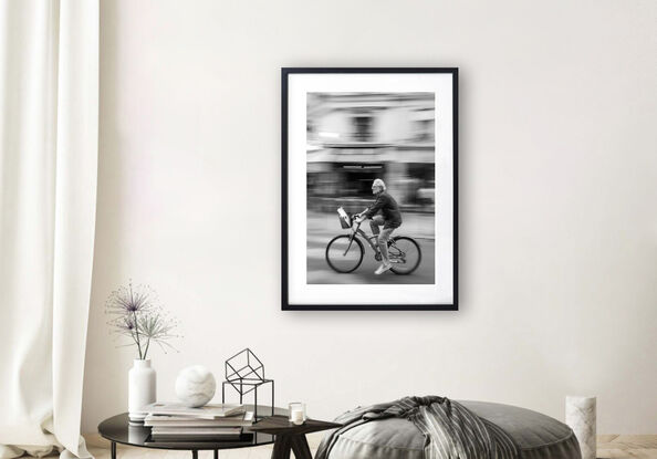 Black and white photograph of cycling in street Paris, France