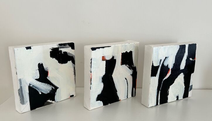 Three pieces black and white with orange.  Each piece  20 x 20 relates to each other and overall creates one art work.