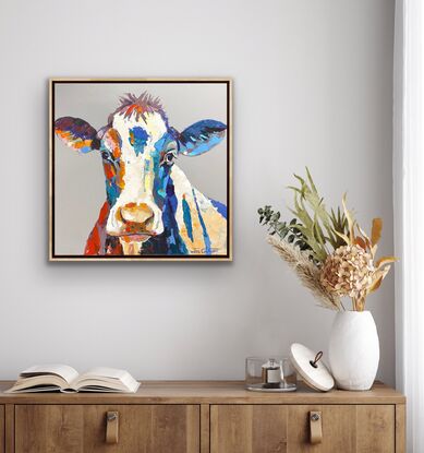 Portrai of a cow on a grey neutral background with pops of colour and texture. 