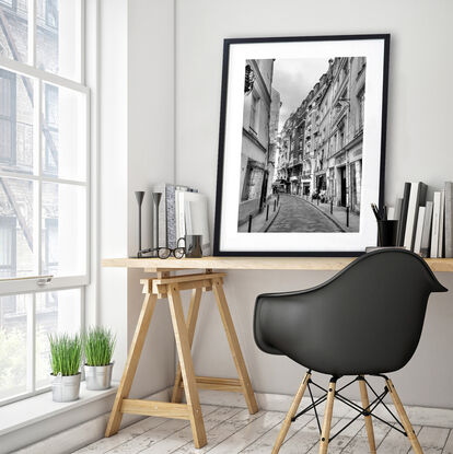 Black and white photograph of curved street in Paris, France