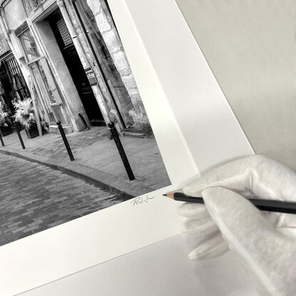 Black and white photograph of curved street in Paris, France