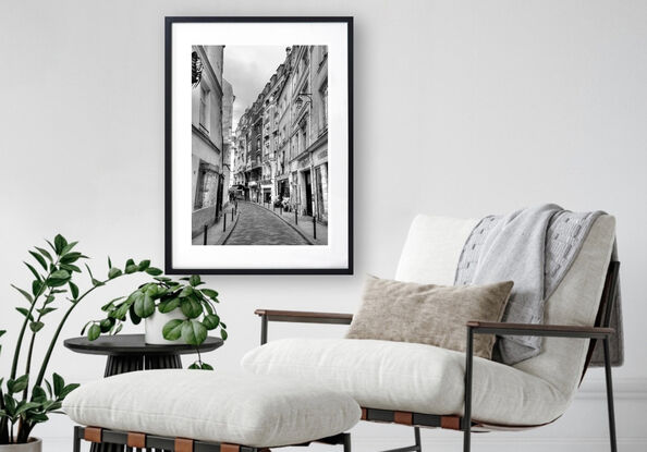 Black and white photograph of curved street in Paris, France