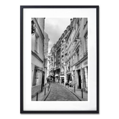 Black and white photograph of curved street in Paris, France