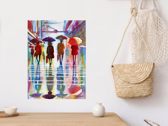 "Raindrops and Reflections" by Christine Beard captures the quiet beauty of a rainy day in the city. This vibrant watercolor painting depicts figures walking under umbrellas, their silhouettes reflected in the wet pavement below. The interplay of colors and light creates a serene yet dynamic atmosphere, showcasing the harmony between urban life and nature's elements. Perfect for those who appreciate contemporary art with a touch of everyday magic, this piece brings the tranquil and reflective mood of a rainy cityscape into your space.






