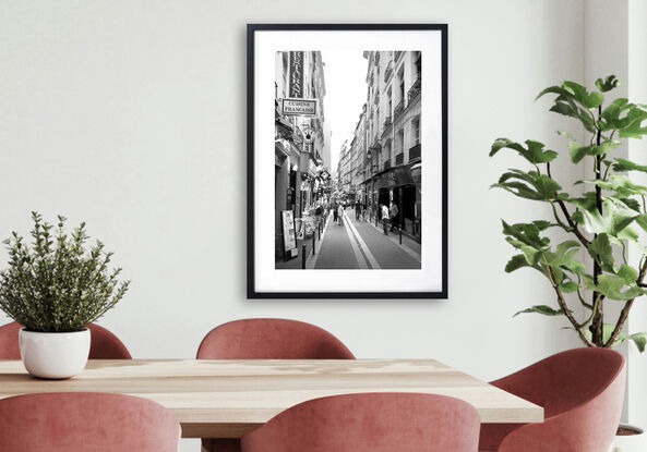 Black and white photograph of narrow street in Paris, France