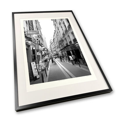 Black and white photograph of narrow street in Paris, France