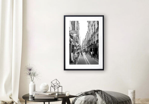 Black and white photograph of narrow street in Paris, France