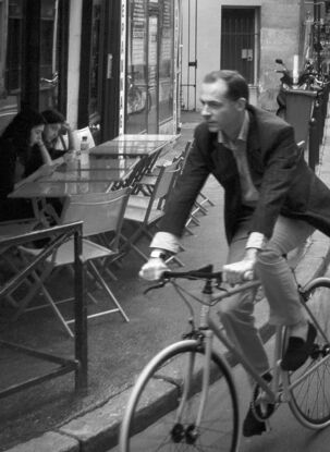 Black and white photograph of narrow street in Paris, France