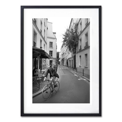 Black and white photograph of narrow street in Paris, France