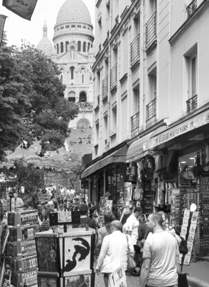 Black and white photograph of narrow street in Paris, France