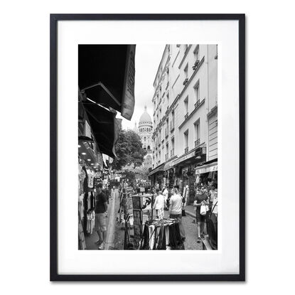 Black and white photograph of narrow street in Paris, France