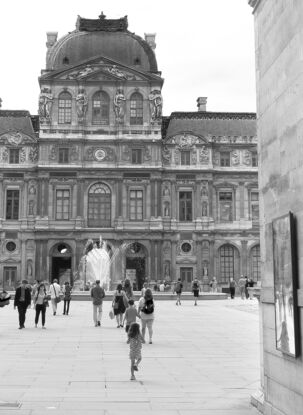 Black and white photograph of narrow street in Paris, France