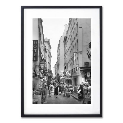 Black and white photograph of narrow street in Paris, France